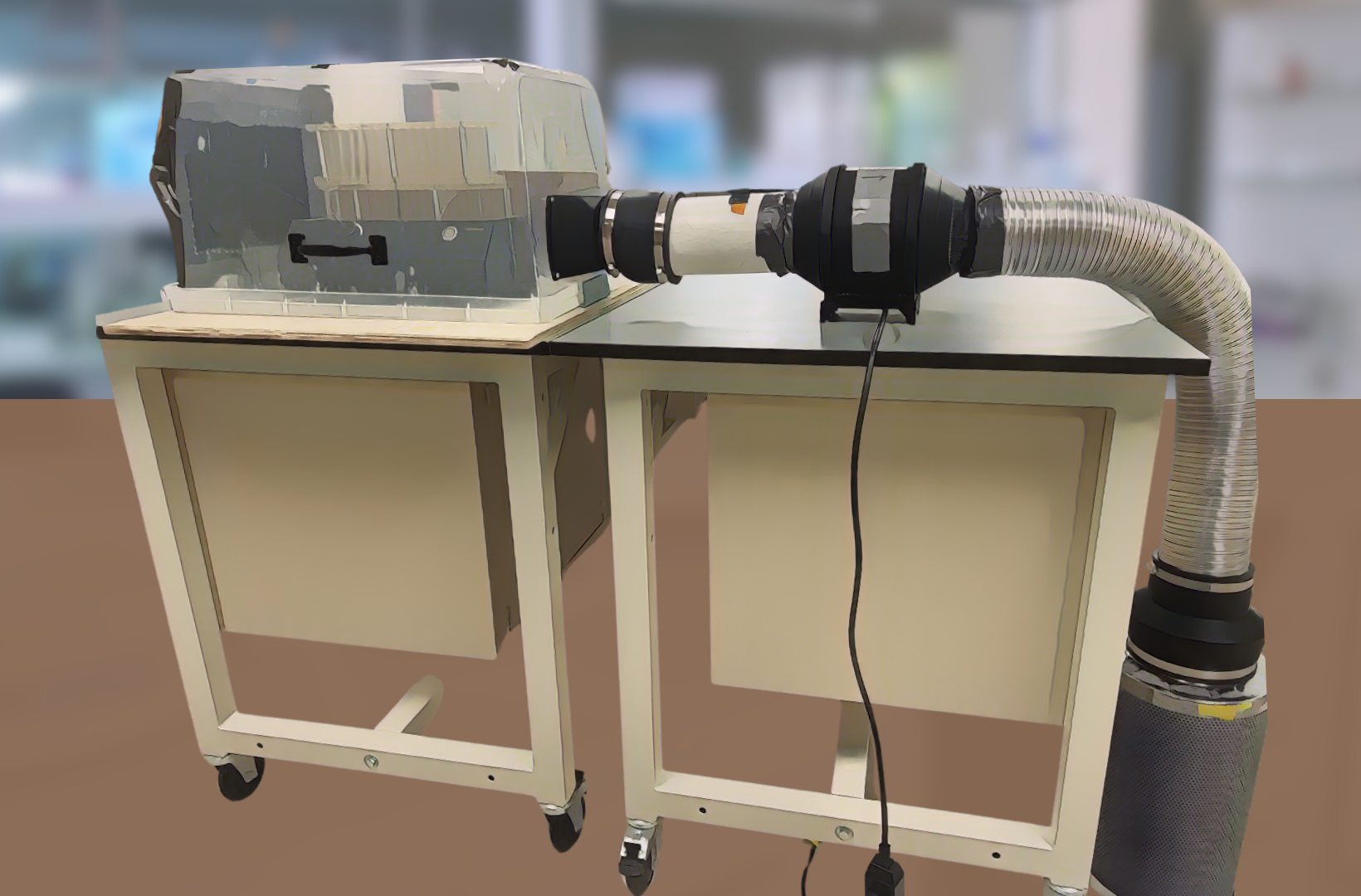 Plastic box with tubes attached sits on top of a table.