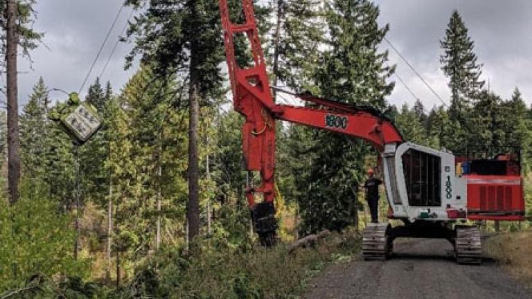 Large machinery on a forested road.